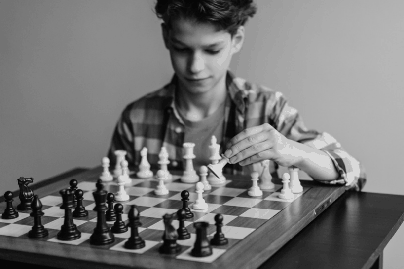 A Boy Playing a Game of Chess