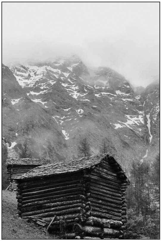 Wooden houses at the foot of a high mountain