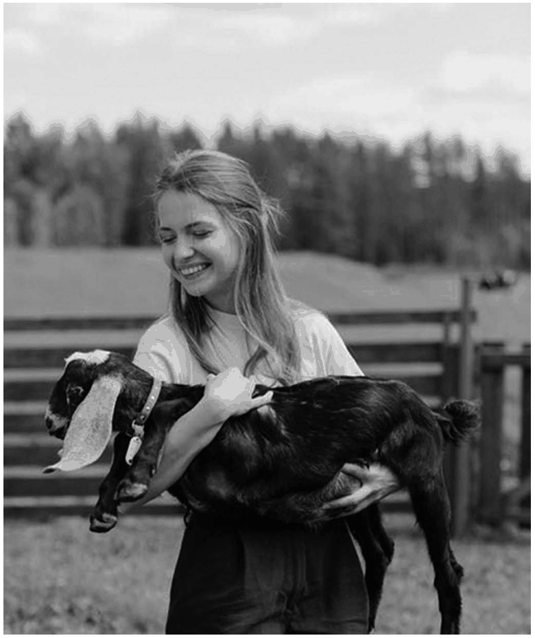 Woman Holding a Black and White Goat