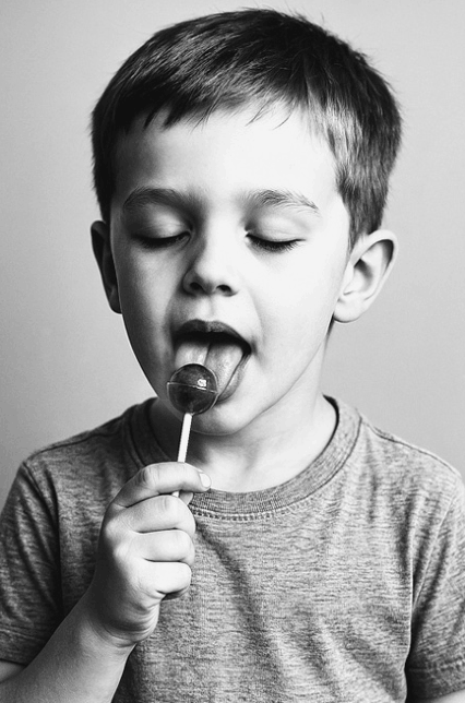 A boy with a lollipop